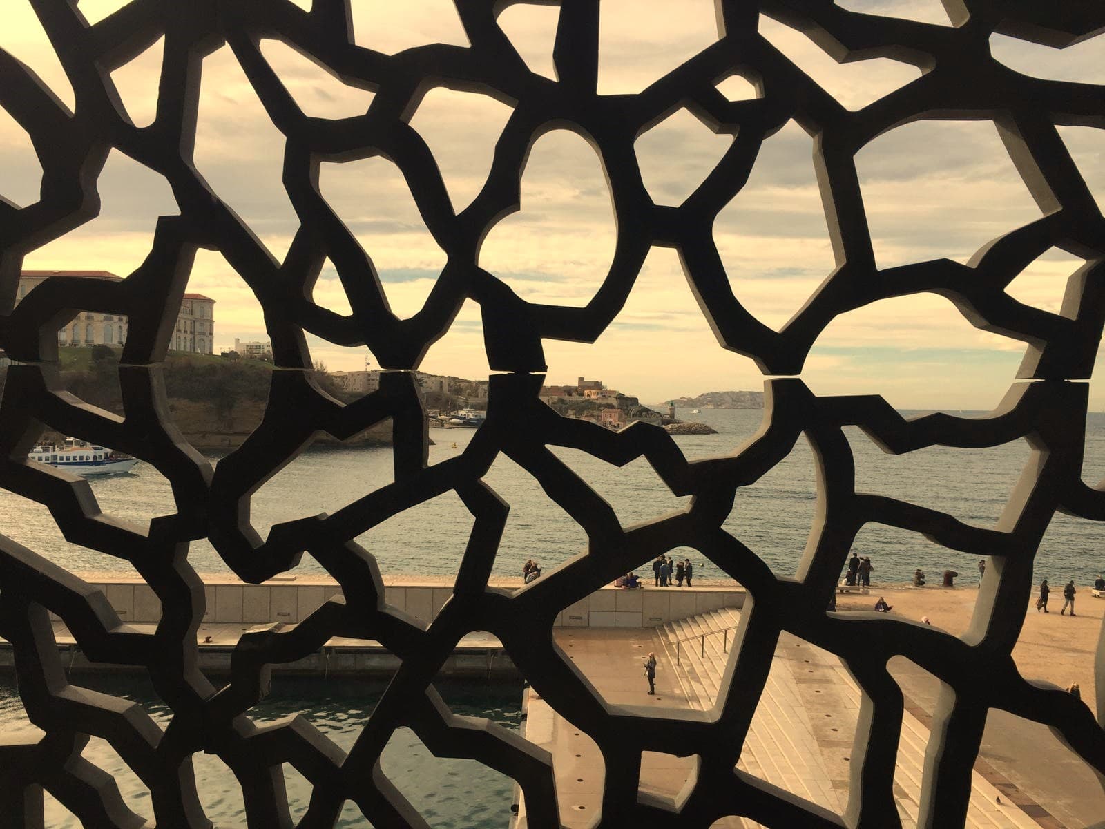 Vista sul mare attraverso una griglia architettonica, viaggio e scoperta
